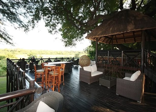 Burchells Bush Lodge wooden deck overlooking the Mpumalanga bushveld with outdoor seating and a thatched lapa